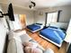 Cozy bedroom with hardwood floors, two queen beds, a sofa and a mounted television at 4151 Nelson Rd, Lake Wales, FL 33898