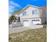 Two-story home with white siding, two-car garage, palm tree, and landscaped front yard at 4151 Nelson Rd, Lake Wales, FL 33898