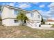 Well-maintained two-story home with a two-car garage, white siding and landscaped front yard at 4151 Nelson Rd, Lake Wales, FL 33898