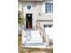 Front entrance with white stairs, wood railings, front door and octagonal window at 4151 Nelson Rd, Lake Wales, FL 33898