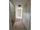 Hallway featuring neutral walls, tile floor, and multiple doorways leading to various rooms in the home at 4151 Nelson Rd, Lake Wales, FL 33898