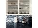 Modern kitchen cabinets stocked with dishes, cups, and bowls above a decorative tile backsplash at 4151 Nelson Rd, Lake Wales, FL 33898