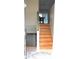 Wooden staircase leading to the upper level, with a door to the basement at 4151 Nelson Rd, Lake Wales, FL 33898