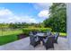 Scenic backyard featuring a lovely water view, outdoor seating, and lush landscaping at 4224 Clarice Estates Dr, Windermere, FL 34786
