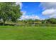 Expansive backyard view showcases lush greenery and a tranquil lake view at 4224 Clarice Estates Dr, Windermere, FL 34786