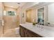 Bright bathroom features a walk-in shower, a neutral color palette, and a large mirror above a vanity at 4224 Clarice Estates Dr, Windermere, FL 34786