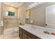 Bathroom featuring vanity, large mirror, and shower-tub combo with glass enclosure at 4224 Clarice Estates Dr, Windermere, FL 34786