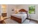 Cozy bedroom with a wooden bed frame, plush bedding, and ample natural light at 4224 Clarice Estates Dr, Windermere, FL 34786
