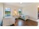 Bright bedroom featuring two twin beds, hard wood floors, and outdoor views at 4224 Clarice Estates Dr, Windermere, FL 34786