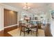 Dining area with wood flooring, views of kitchen, and adjacent modern wall decor at 4224 Clarice Estates Dr, Windermere, FL 34786
