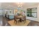 Dining area next to kitchen, showcasing modern decor, wood floors, and natural light at 4224 Clarice Estates Dr, Windermere, FL 34786