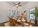 Dining room featuring a wood table set for eight, modern ceiling fan, and a doorway to the living room at 4224 Clarice Estates Dr, Windermere, FL 34786
