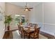 Formal dining room with wainscoting, hardwood floors, and a view to the yard at 4224 Clarice Estates Dr, Windermere, FL 34786