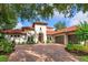Stunning Mediterranean-style home featuring a terracotta tile roof and lush landscaping at 4224 Clarice Estates Dr, Windermere, FL 34786