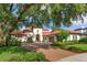 Beautiful home boasts a red tile roof, manicured lawn, and a paver driveway at 4224 Clarice Estates Dr, Windermere, FL 34786