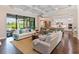 Open-concept living room with seamless flow to kitchen and backyard with hardwood floors at 4224 Clarice Estates Dr, Windermere, FL 34786