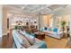 Open-concept living room with seamless flow to kitchen; coffered ceiling and hardwood floors at 4224 Clarice Estates Dr, Windermere, FL 34786