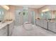 Luxurious bathroom with dual vanities, soaking tub, and walk-in showers at 4224 Clarice Estates Dr, Windermere, FL 34786