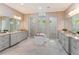 Elegant bathroom featuring dual vanities, a freestanding tub, and separate glass-enclosed showers at 4224 Clarice Estates Dr, Windermere, FL 34786