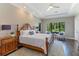Serene main bedroom with tray ceiling, large window, and comfortable seating area at 4224 Clarice Estates Dr, Windermere, FL 34786