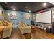 Home theater featuring comfortable seating, large screen, and rich hardwood floors at 4224 Clarice Estates Dr, Windermere, FL 34786