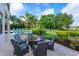 Cozy outdoor patio area with comfortable seating, surrounded by lush landscaping at 4224 Clarice Estates Dr, Windermere, FL 34786