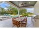 Outdoor patio with dining, cooking, and seating area overlooking the pool and backyard at 4224 Clarice Estates Dr, Windermere, FL 34786