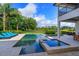 A beautiful outdoor swimming pool with integrated jacuzzi and comfortable lounge chairs at 4224 Clarice Estates Dr, Windermere, FL 34786