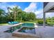 Outdoor swimming pool featuring integrated jacuzzi, lounge chairs, and lush landscaping at 4224 Clarice Estates Dr, Windermere, FL 34786
