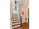 Elegant staircase features hardwood treads, white risers, and natural light from large windows at 4224 Clarice Estates Dr, Windermere, FL 34786