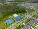 Aerial shot of a community with tennis, basketball, and volleyball courts, plus a playground and green spaces at 4338 Finch Ln, Kissimmee, FL 34746
