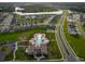 Scenic aerial perspective showcases a community pool, clubhouse, and surrounding houses near a lake at 4338 Finch Ln, Kissimmee, FL 34746