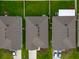 Overhead view of homes featuring well-maintained lawns and coordinated rooflines at 4338 Finch Ln, Kissimmee, FL 34746