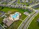 Aerial view of a community pool, playground, clubhouse, and surrounding residential area at 4338 Finch Ln, Kissimmee, FL 34746