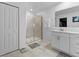 Clean bathroom features tiled floors, a glass enclosed shower, a white vanity with drawers and white walls at 4338 Finch Ln, Kissimmee, FL 34746