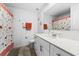 Well-lit bathroom with a single sink vanity, quarts countertops, and decorative shower curtain at 4338 Finch Ln, Kissimmee, FL 34746