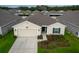 Inviting single-Gathering home boasting a two-car garage, manicured lawn, and a welcoming entryway at 4338 Finch Ln, Kissimmee, FL 34746