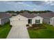 Charming single-story home featuring a neutral color palette, well-maintained landscaping, and a two-car garage at 4338 Finch Ln, Kissimmee, FL 34746