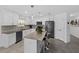 Modern kitchen features white cabinets, stainless steel appliances, center island, and tiled floors at 4338 Finch Ln, Kissimmee, FL 34746