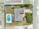 Aerial view of fenced backyard, home, and pool; shed also on property at 4607 Pine Lake Dr, St Cloud, FL 34769
