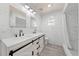 Bathroom featuring double vanity, marble tile, and black fixtures at 4607 Pine Lake Dr, St Cloud, FL 34769