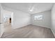 This bedroom features wood-look flooring, a ceiling fan, closet and a window at 4607 Pine Lake Dr, St Cloud, FL 34769