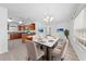 Bright dining room with white walls and floors, with a view of kitchen and natural light at 4607 Pine Lake Dr, St Cloud, FL 34769