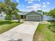 View of the single-story home featuring an attached garage and concrete driveway at 4607 Pine Lake Dr, St Cloud, FL 34769