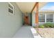 The front porch has a decorated front door, tiled floor, and a window with orange shutters at 4607 Pine Lake Dr, St Cloud, FL 34769