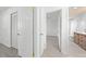 Hallway view to a bathroom with modern vanity and tiled shower, plus a look to a bedroom at 4607 Pine Lake Dr, St Cloud, FL 34769