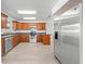 Spacious kitchen boasts wood cabinets, stainless steel appliances, and convenient layout at 4607 Pine Lake Dr, St Cloud, FL 34769