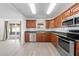 Well-equipped kitchen featuring wood cabinets, modern appliances, and a view of the backyard at 4607 Pine Lake Dr, St Cloud, FL 34769