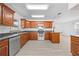 Well-lit kitchen boasting wood cabinets, stainless steel appliances, a breakfast bar, and an open layout at 4607 Pine Lake Dr, St Cloud, FL 34769