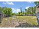 Large, grassy backyard with a utility access point and fenced perimeter, offering ample space at 6396 Bennett Ct, St Cloud, FL 34771